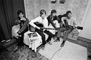 The Small Faces pop group pictured in a provincial hotel room as they watch their latest