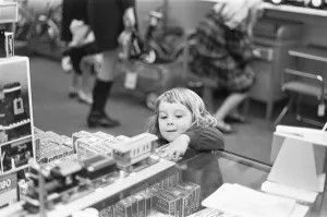 Department Store Prints: Small girl looks on longingly at the latest Lego set in the toy department of Heelas