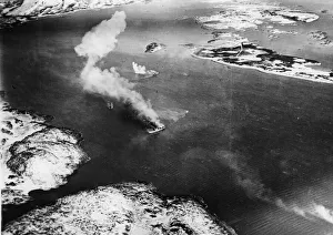 Target Prints: The small supply vessel (in foreground) well on fire and being beached; in centre