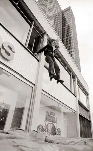 With a smile on her face stunt girl Sue Crosland plunges 30ft from a window in the Thames