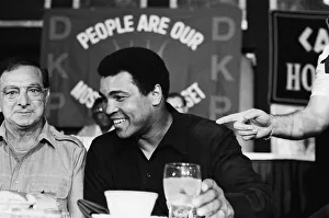 A smiling Muhammad Ali at pre fight press conference for his upcoming fight with Larry