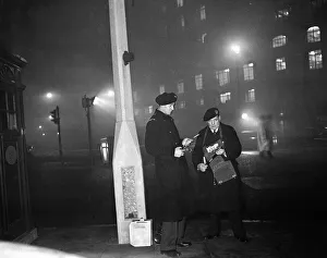 Smog wardens holding flares in thick fog in Central London. 5th January 1956