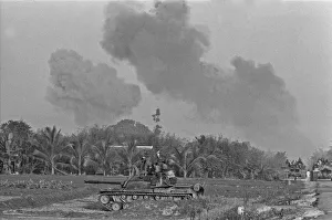 Smoke rising in the distance as armoured units of the South Vietnamese army shell Viet