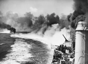 War At Sea Prints: Smoke screen put up by US destroyers whilst circling the British cruiser Dido