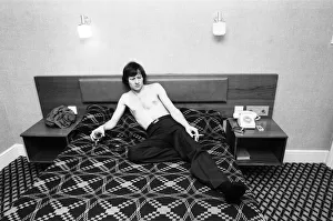 Snooker player Alex Hurricane Higgins relaxing with a drink