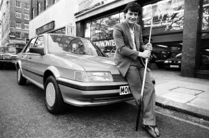 00677 Prints: Snooker player Jimmy White poses beside a new model Austin Montego. 11th May 1984