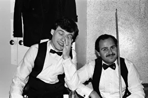 Snooker player Jimmy Whiteshares a joke with a fellow snooker player in the dressing room