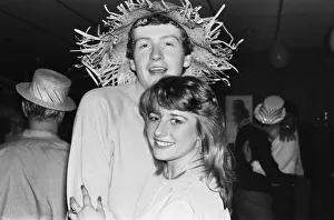 Snooker player Steve Davis wearing a straw hat with a young fan. 8th June 1981