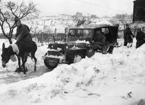 01467 Prints: Snow falls on the 8th Army front. British troops clear the main route forward