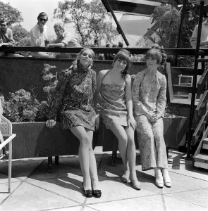 Socio Boutique in London shows of some of its new fashions Three girls sitting