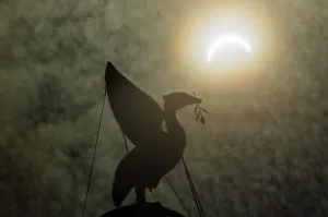 01106 Prints: The solar eclipse pictured behind the Silhouette of the Liver Bird on a tower of