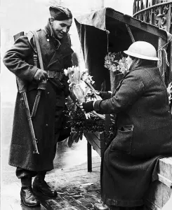 00203 Prints: Soldier buying flowers from well protected flower seller during WW2