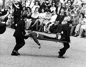 Stretcher Prints: A soldier of the Scots Guard is stretchered off the parade ground during the Trooping of