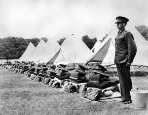 Tents Prints: A soldier stands to attention beside neatly folded kit during an inspection of 52nd