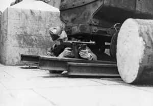 01459 Prints: Soldier taking advantage of cover as he fires his gun in a South Wales training exercise
