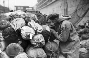Goodbye Prints: Soldier writes a farewell card home before embarking on a troopship bound for the Italian