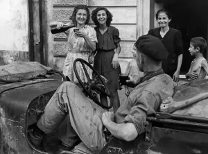Jeep Prints: Soldiers of the 8th Army receive a great welcome from local Sicilian girls as the port of
