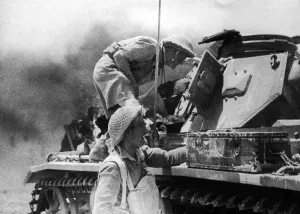 Soldiers from the 8th Army seen here examining a derelict German tank