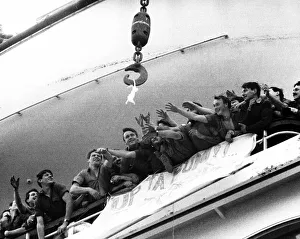 Soldiers aboard the QE2 reaching out for a bra that is up for grabs belonging to a Lance
