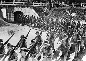00411 Prints: Soldiers of the Australian Imperial Force march into the parade ground in Malaya during