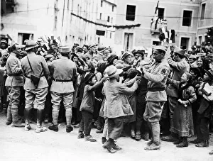 Soldiers of the French forces operating in Italy distributing French flags to