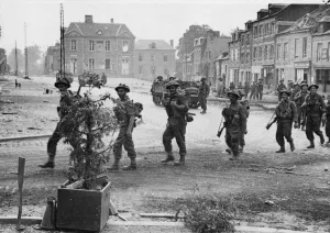 Soldiers of the Kings Shropshire Light Infantry advance through Vassy to take up holding