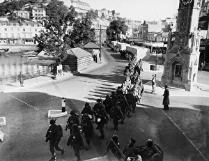 D Day Prints: US soldiers march along the strand in Torquay. June 1944 prior to embarking on ships that