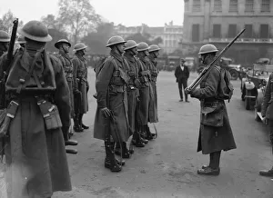 Tin Helmets Prints: Soldiers parade on Horseguards Parade in London before patrolling the streets on the 10th