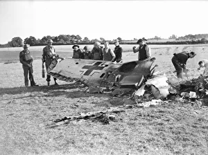 Soldiers, Policemen and local farmers inspect the wing of a German Messerschmitt BF109E