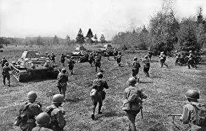 Soldiers of the Soviet Red Army supported by tanks attacking enemy fortifications during