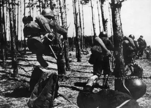 Former Ussr Prints: Soldiers of the Soviet Red Army surmounting a barbed wire obstacle while advancing to
