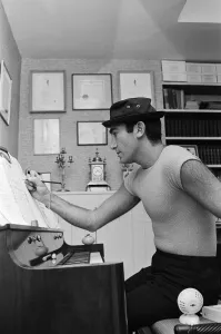Songwriter and composer Lionel Bart in his flat in South Kensington