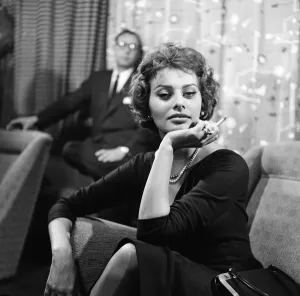 Italian Prints: Sophia Loren pictured sitting in a chair at London Airport