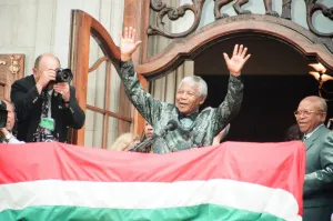 South African President Nelson Mandela waving to the crowds from the balcony of South