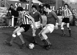 South Bank number 7, Hume, is hustled off the ball by the Evenwood defence