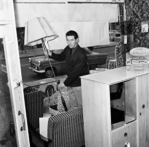Southampton and England footballer Terry Paine at work as a furniture salesman