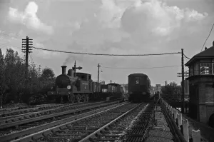 1938 Prints: Southern Railways goods train passes a three carriage Electric Multiple Unit train on a