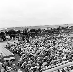 Southport, Merseyside, crowds of people relax in the Floral Hall Gardens as they listen