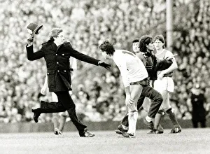 Spectator runs onto football pitch chased by policeman Arsenal v Tottenham