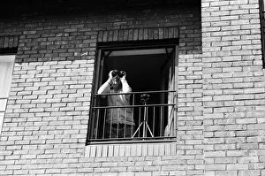 A spectator watching Princess Diana visiting the Boyd Court Guinness Trust Housing Estate