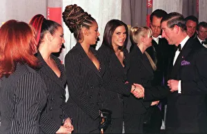 Spice Girls Geri Halliwell Mel C Mel B look on as Victoria Adams shakes hands with Prince