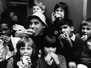 Boys And Girls Prints: Spike Milligan actor with children eating hotdogs - June 1972