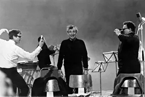 Spike Milligan, Peter Sellers, and Harry Secombe have a mock duel with cameras during a