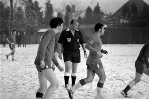 00254 Prints: Sport Amateur football youth game in action in the snow near Maidshow between two local