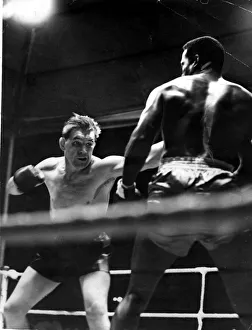 Sport - Boxing - Tommy Farr with his right hand poised fires a left at Al Hoosman during