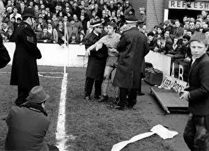Sport: Football: West Ham 0. v. Everton 1. Injured Tommy Wright is helped by