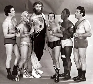Sport. Wrestling Men in Lycra singing with flowers wearing assorted trunks July