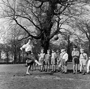 Sports mistress Miss Reid teaches football to the boys of Park Hill School, Kingston