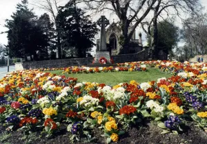 Christian Prints: Spring flowers around a war memorial outside St Andrews church, Haughton