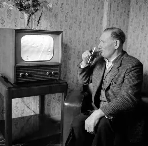 Former Spurs footballer Jimmy Dimmock seen here at home watching his beloved Spurs